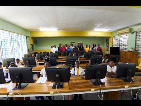Vaz Prep and John Austin students seated in the refurbished Lloyd Carney Computer Lab at Vaz Prep in Kingston. 