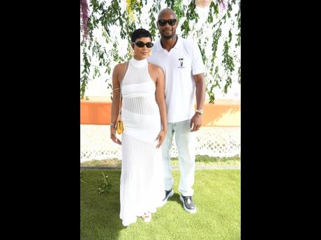 Credit: Antoine Lodge Making an appearance on the social runway in matching white are sub-10 king, Asafa Powell, and his queen, wife Alyshia.