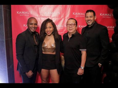 Birthday celebrant Kamal Powell poses for photos with (from left) attorney-at-law Roshani Howard; Ribbiz Lounge Director Brian ‘Ribbi’ Chung, and Coldfield Manufacturing’s Brett Wong.