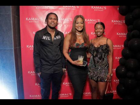 Tanya Lee Perkins, head of Leep Marketing, is flanked by Andre Blake, captain of the Reggae Boyz and JustBet ambassador and his wife, Shauna Kaye Blake. 