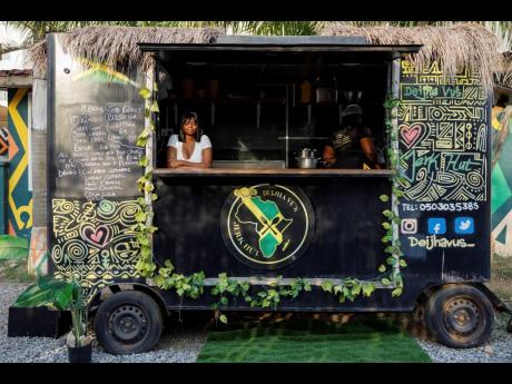 Deijha Gordon, 33, poses for a photograph in her food truck in Accra, Ghana.