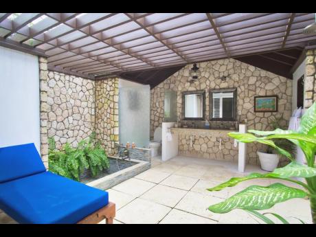 Credit: Contributed Is this a bathroom? Oh, yes, it is! Stone and glass walls, an open shower, a sunken tub, double basins — partly open to the sky.