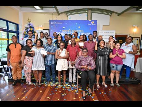 Credit: Contributed NCB Foundation’s Grant a Wish beneficiaries gather to celebrate at the reveal ceremony held in Kingston recently.