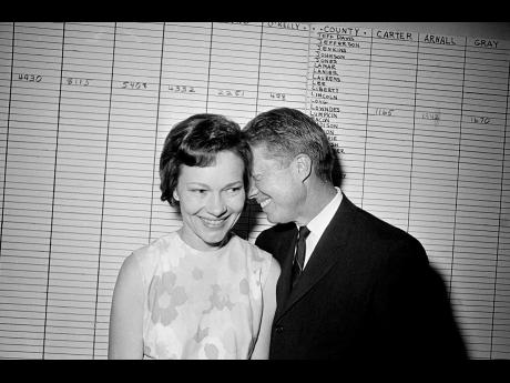 Jimmy Carter hugs his wife, Rosalynn, in this September 15, 1966, file photo.