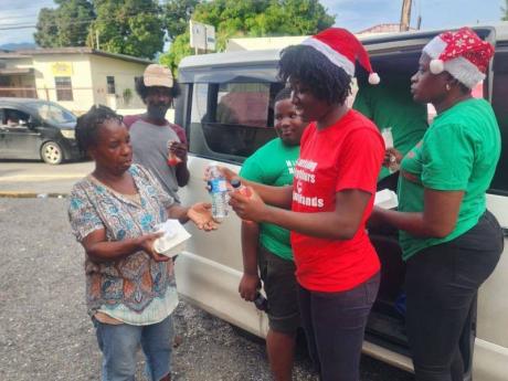 Sherinae Brown (second from right) and her team feed the less fortunate. - Contributed photo