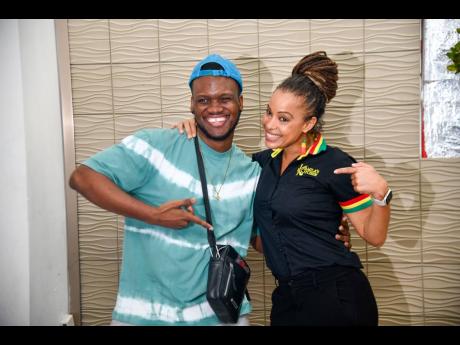 Russhaine ‘Dutty Berry’ Berry celebrates with the woman of the moment, Kamila McDonald, as she unveils the new location of Kamila’s Kitchen in downtown Kingston.