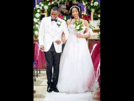 Attorneys-at-law Demoy and Jodi-Kay take their first walk as husband and wife.