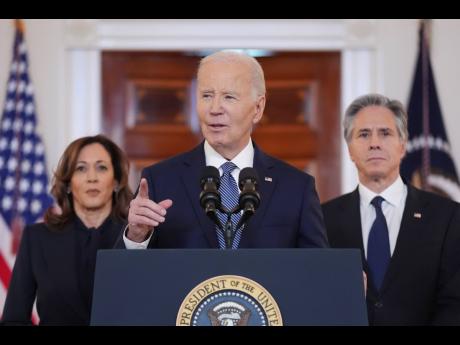 President Joe Biden, center, with Vice President Kamala Harris, left, and Sec. of State Anthony Blinken, right, speaks in the Cross Hall of the White House on the announcement of a ceasefire deal in Gaza and the release of dozens of hostages after more tha