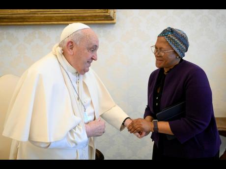 In this picture made available on Thursday, January 16, 2025 by Vatican Media, Pope Francis wears a sling on his right arm, due to a fall earlier in the day, while meeting with FAO Programme Committee Chairperson on World Food Security Nosipho Nausca-Jean 