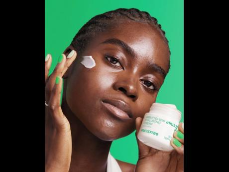 Nigerian SAINT supermodel Tomiwa is one of the faces of the new Innisfree global campaign. She is photographed here with the Korean skincare brand’s green tea seed hyaluronic cream.