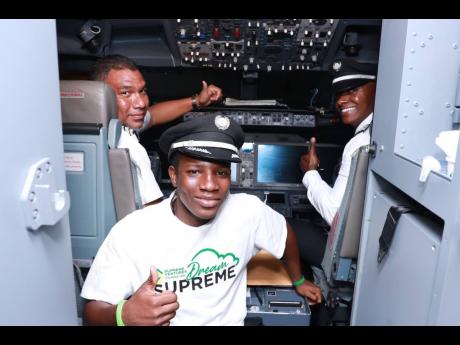Credit: Contributed An excited Jordan Saunders (centre) meets Captain Louis Hunter (left) and First Officer Victor Dawkins.