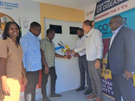 Health Minister Dr Christopher Tufton (second right) participates in a ribbon-cutting exercise for the official opening of the newly revamped Green Pond Health Centre in Green Pond, St James, on Thursday. Also pictured (from left) are Velsa Pusey, district