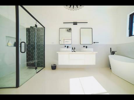 Bathrooms impress with glass-enclosed showers, soaking tubs, and floating double-basin vanities.