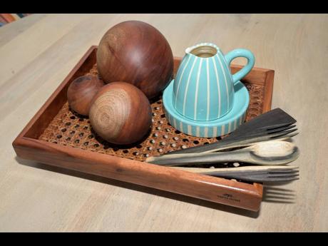 Some of the artisan decorative balls, wooden utensils and a ceramic mini kettle sold by Veeva Home. 