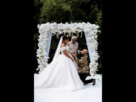 Taking a knee, the dashing groom turned on the charm for his beautiful bride during their wedding ceremony at Boone Hall Oasis in Stony Hill, St Andrew.