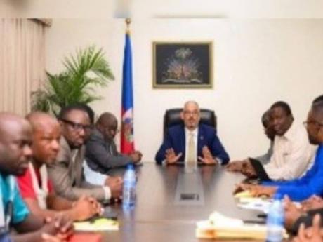 Haiti’s Prime Minister Alix Didier Fils- Aimé (head of table) chairs meeting between government officials and trade unions ending strike by teachers.