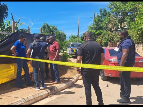 Credit: Ruddy Mathison photo Police carry out investigations at the scene of a shootout in Tryall Heights, St Catherine, in August where two persons died.
