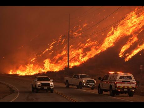 Credit: Fighter fighters monitor flames caused by the Hughes Fire along Castaic Lake in Castaic, California, Wednesday, January 22, 2025. (AP Photo/Marcio Jose Sanchez)