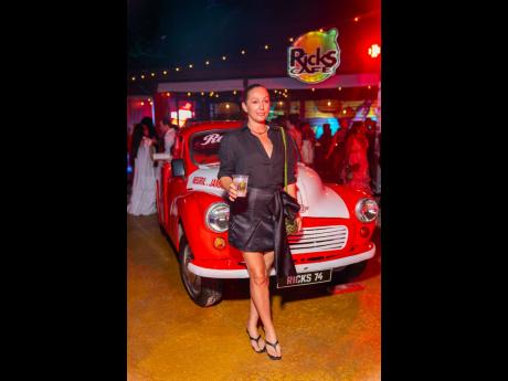 Credit: Contributed Entrepreneur Shontelle Pinch rocks a sleek, black, long-sleeve blouse, paired with a structured, mini skirt with an asymmetrically draped bow detail.