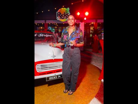 Credit: Contribited Nichole Wong flaunts a printed Prada top paired with high-waisted cargo pants, completing the laid-back look with sleek, black Havaianas sandals.