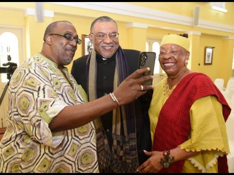 Professor Kwame Dawes (centre), Poet Laureate of Jamaica 2025-2028, poses for pictures with  Fabian Thomas (left) and Dr Amina Blackwood-Meeks.