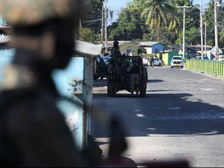 Heavy police and military presence on Wellington Street in Spanish Town, St Catherine, on the border of Ellerslie Pen (left) and Tawes Meadows (right), on Thursday, hours after alleged don Othniel Lobban’s death.