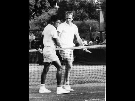 All-Jamaica champion, Richard Russell (left), is congratulated by Victor Fisher in 1963.