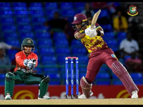 West Indies Women’s captain Hayley Matthews (right) plays a square cut on her way to an unbeaten 60 in the first T20I against Bangladesh at Warner Park on Monday.