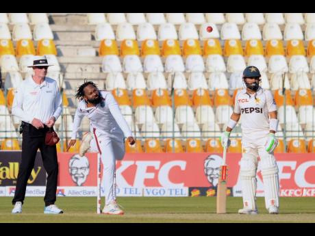 West Indies’ Jomel Warrican (centre) bowls a delivery on Day One of the second Test match against Pakistan in Multan, Pakistan, on Saturday. Looking on at right is Pakistan’s Mohammad Rizwan.