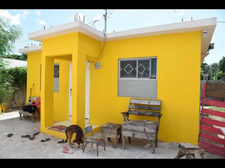 TOP LEFT: A modified National Social Housing Programme unit in Hopeful Village in Arnett Gardens, St Andrew. Thia Jones explained that she and her neighbour, who also recieved a home under the initiative, have blocked out the lower sections of the original