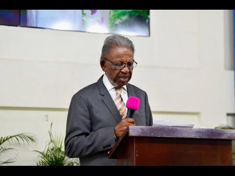 Franklin Williams, of the Holmwood Technical High School Family Class of 1964, pays tribute at the funeral.