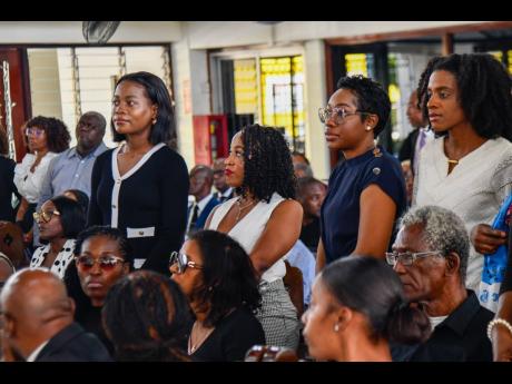 Gleaner journalists (from left) Sashana Small, Tanesha Mundle, Kimone Francis, and Debbie-Ann Wright, stand in solidarity during the tribute from the company. Also standing in background are Gleaner journalist Shaunette Wright and former Gleaner editor And