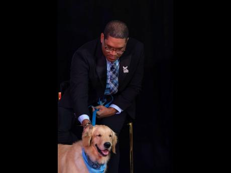 Credit: Contributed photos Joseph Brown, general curator at the Hope Zoo Preservation Foundation, gently pats the famous Dr Teddy Barks at the MDS M-Powered: Gone to the Dogs conference on January 26.