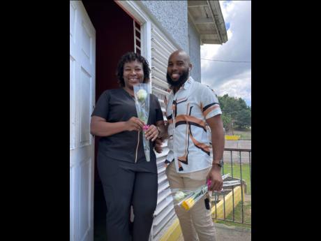 Jason Brown (right) presenting a rose to Shana Brissett, staff member, SOS Children’s Village on International Women’s Day.