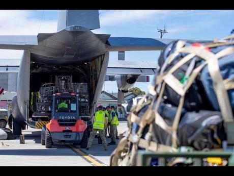 A Royal New Zealand Air Force Hercules C130 H is loaded up with supplies to deliver to Vanuatu, in Auckland, New Zealand, Wednesday, December 18, 2024, following a strong earthquake that struck just off the coast of Vanuatu in the South Pacific Ocean, on D