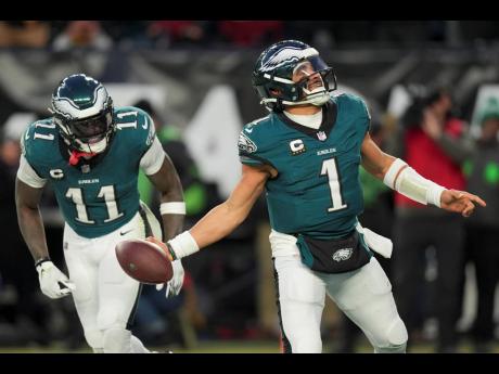 Philadelphia Eagles quarterback Jalen Hurts celebrates after scoring against the Washington Commanders during the second half of the NFC Championship NFL football game on Sunday, January 26, 2025, in Philadelphia.