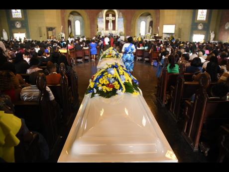The coffins at the entrance of the Cathedral of the Most Holy Trinity at the start of the funeral on Saturday.