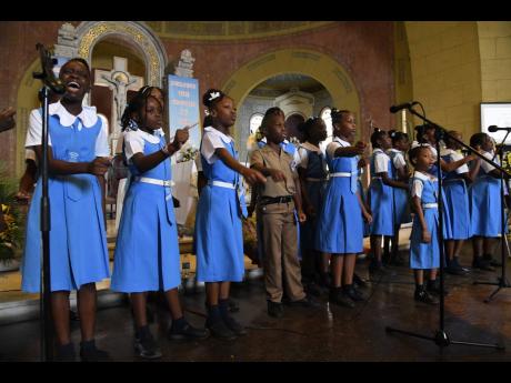 The Jessie Ripoll Primary School Choir paying tribute to their former principal, O’Neil Stevens, and his wife, Camesha Lindsay-Stevens, during their funeral on Saturday.