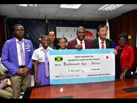 Permanent Secretary in the Ministry of Education, Skills, Youth and Information, Dr Kasan Troupe (third left), shares in the presentation of a cheque by the Embassy of Japan in Jamaica to purchase a school bus for Bustamante High School in Clarendon. Shari