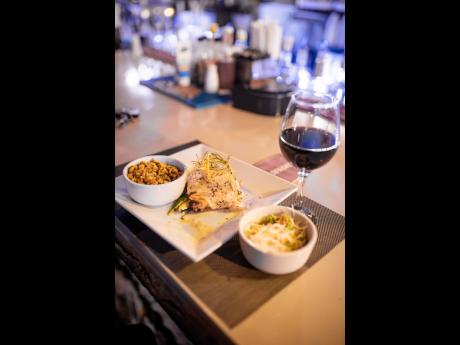 Plantation Smokehouse continues to make waves with this saucy salmon masterpiece, served with fresh corn salsa and a side of vegetables and paired with a glass of red wine.