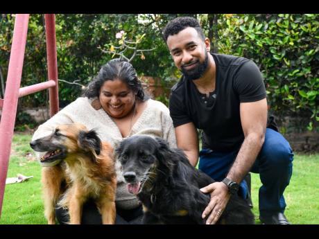 Elise Dash McLeod (left) and Mikhail McLeod with their rescue dogs Benji (front left) and Lady.