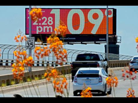 A digital billboard displays an unofficial temperature, July 2023, in downtown Phoenix. 