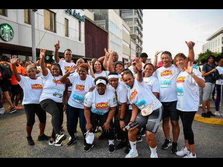 Credit: Matthew McKoy/Photographer Participants from Chung’s Catering Service take time for a photo at the Sagicor Sigma Run 2025.