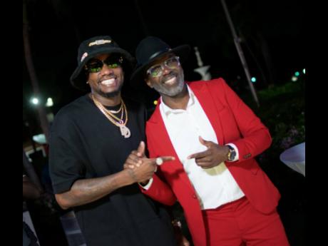 Dancehall entertainer and GraceKennedy Group Brand Ambassador Ding Dong (left) and event host Ity Ellis pause for a photo op.
