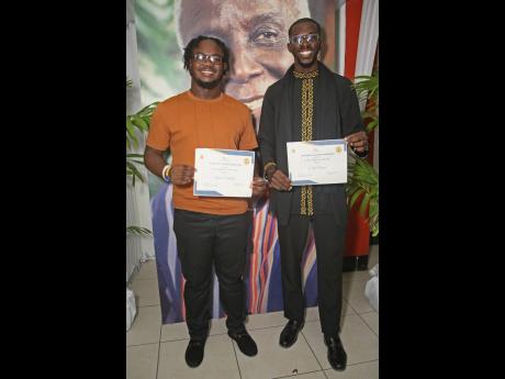 All smiles from Rex Nettleford Foundation Award recipients Antoine Mitchell (left) and Curtis Clennon.
