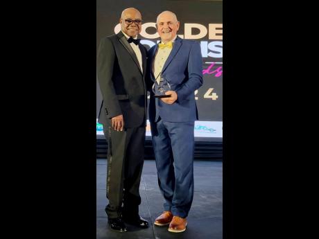 Pierre Battaglia beams with pride after receiving the Jamaica Tourist Board’s (JTB) Golden Tourism Day Award from Tourism Minister Edmund Bartlett last December.
