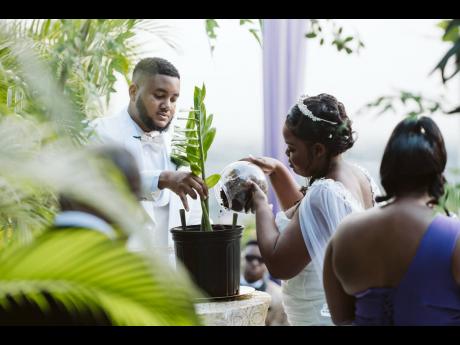 Credit: Contributed Duronie and Kadejha plant a tree, symbolising the roots of their love and the growth to come.