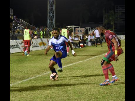 Mount Pleasant’s Alex Marshall (left) attempts to dribble past Montego Bay United’s Jourdain Fletcher during their Jamaica Premier League match at the Montego Bay Sports Complex on Monday.