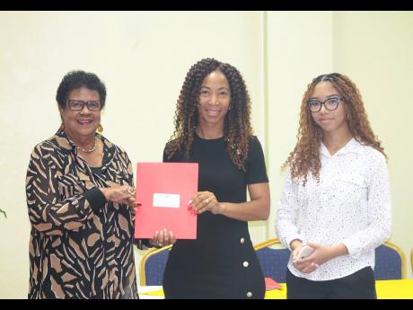 Eleanor Jones (left), deputy chairperson for the EFJ, shares a photo with representatives from Development Beyond Horizons at the recent grant-signing ceremony.