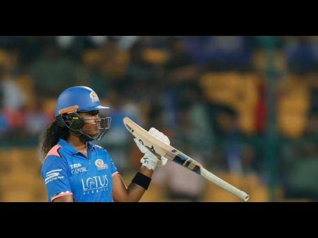 Hayley Matthews gestures in celebration of scoring a half-century for the Mumbai Indians in their Women’s Premier League game against the UP Warriorz at the M Chinnaswamy Stadium yesterday.